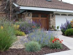 a house with lots of flowers in front of it