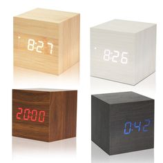 four wooden cubes with the numbers on them and one is displaying the same time