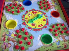 a close up of a board game with cherries on it