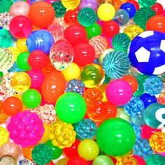 there are many different colored balloons and balls