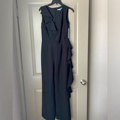 Women’s Antonio Melani Eva Ruffle Front Jumpsuit/Romper In Black Nwt! New With Tags, This Adorable Romper Has Never Been Worn, Has Stayed Inside A Garment Bag Since Purchase, And Comes From A Smoke And Pet-Free Home. It’s The Perfect Outfit For Any Occasion- Date Night, Dinner, Or Evening Wedding Guest. Color: 001 Midnight Waltz Size: Us 2 | Uk 6 | Europe 32 -Crepe Fabrication -V-Neckline -Sleeveless -Ruffle Trim Detail From Shoulder To Opposite Leg -Full Length, Straight Hemline -Invisible Back Sleeveless Ruffled Jumpsuits For Formal Occasions, Fitted Ruffle Jumpsuits And Rompers For Work, Formal Sleeveless Ruffled Jumpsuits And Rompers, Fitted Ruffled Jumpsuits And Rompers For Work, Fitted Ruffles Jumpsuits And Rompers For Work, Formal Sleeveless Ruffled Jumpsuit, Fitted Black Jumpsuit With Ruffles, Black Ruffled Jumpsuits And Rompers For Work, Black Workwear Jumpsuits And Rompers With Ruffles