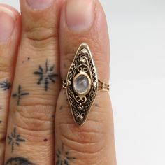 Estate 14k moonstone ring 2.2 grams. size 4.5. unmarked acid tests for 14k. great shape. 6.32mm by 4.87mm moonstone. 26mm wide full ring. better in person. beautiful moonstone ring. estate . was told by estate its a ring got in france. Gold Celestial Moonstone Ring In 14k, Gold Sterling Silver Hallmarked Moonstone Ring, Antique Oval Moonstone Ring, Gold Celestial Moonstone Ring With Rose Cut Diamonds, Elegant Brass Moonstone Ring, Antique 14k Gold Moonstone Ring, Hallmarked Yellow Gold Moonstone Ring, Victorian 14k Gold Moonstone Wedding Ring, Victorian Moonstone Ring For Anniversary