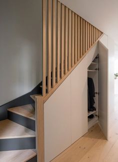 an open closet under the stairs in a house