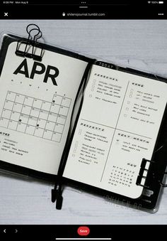 an open notebook with the word apr written on it and a clipboard attached to it