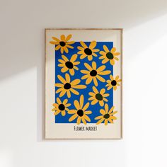 a blue and yellow flower print hangs on the wall