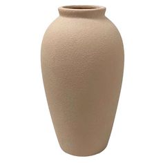 a large beige vase sitting on top of a white table