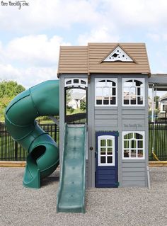 a play house with a slide in front of it