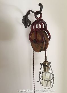 an old fashioned light fixture hanging from the wall