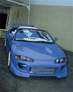 a blue sports car parked in a garage