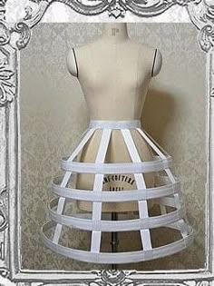 a mannequin wearing a white dress made out of paper