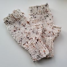 two knitted mittens sitting on top of each other