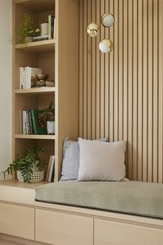 a bed with pillows and bookshelves in a room