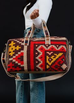 Our best selling duffel bag will be the best companion on your next getaway! This brown with red, tan, mustard and pink Aztec inspired pattern duffel is a statement bag for a fun weekend away! Brown with red, tan, mustard and pink Aztec inspired duffel Zipper closure with interior zipper and 2 small open pockets Measures 20" x 11" x 8" Removable strap Designed in the U.S.A. Produced in India.  100% Cotton Lining: 100% Polyester Aztec Bag, Brown With Red, Statement Bag, Printed Handbags, Boho Bags, Duffel Bags, Travel Duffel, Duffel Bag Travel, Cute Bags