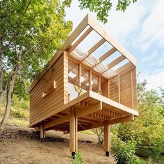 a wooden structure sitting on top of a dirt field