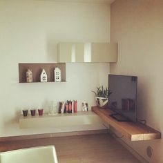 a tv sitting on top of a wooden shelf