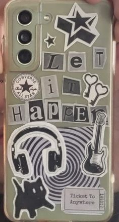 someone holding up their cell phone case with stickers on the front and back side