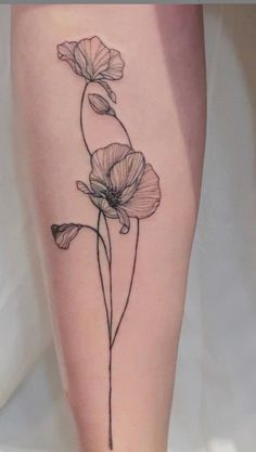 a small flower tattoo on the leg