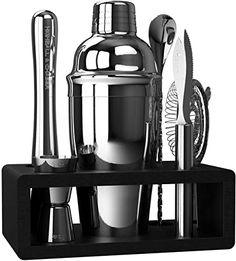 an assortment of kitchen utensils are displayed on a black shelf, including a cocktail shaker and knife