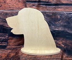 a wooden cutout of a dog's head on top of a piece of wood