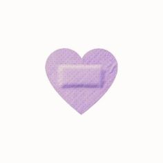 a purple heart shaped pill sitting on top of a white surface