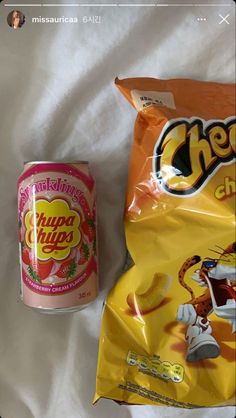 a can of cheetos next to a bag of chips on a white sheet