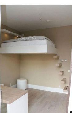 there is a bunk bed in the corner of this room, with stairs leading up to it