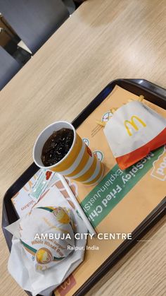 a tray with food and drink on it sitting on a table in an office building