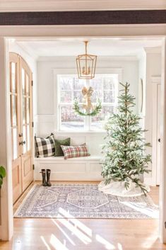 a living room with a christmas tree in the corner