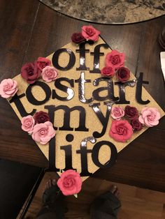 a decorated cap that says offostaat my life on top of a wooden table