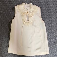 Nwt Cream Color Xs Blouse With Extra Buttons, Sleeveless Cream Silk Top, Summer Beige Silk Blouse, Chic Cream Silk Top, Chic Silk Tops For Spring, Beige Silk Blouse For Summer, Silk Cream Top For Office, Sleeveless Blouse For Office In Spring, Cream Silk V-neck Top, Cream Silk Top For Office