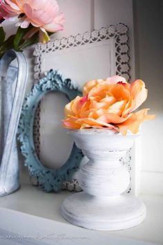 there is a vase with flowers in it on the shelf