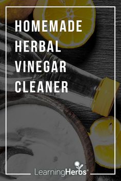 homemade herb vinegar cleaner with lemons on the side