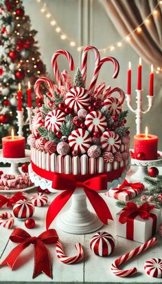 a christmas cake decorated with candy canes and candies is surrounded by other holiday decorations