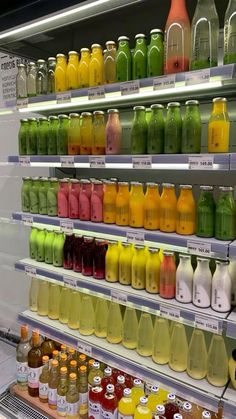 many different types of juices are on display in a grocery store, and there is no image here to provide a caption for