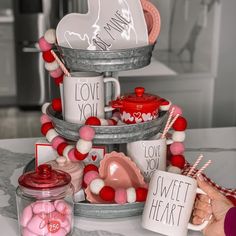 a table topped with lots of valentine's day items and candy canes on top of it