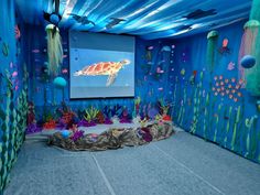 an underwater themed room with a projection screen