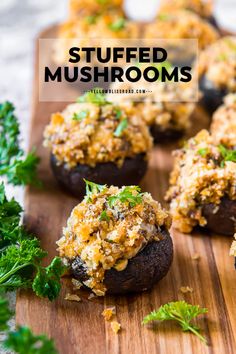 stuffed mushrooms on a wooden cutting board with parsley sprinkled on top and text overlay