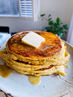 a stack of pancakes with butter on top