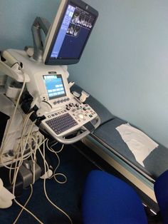 an operating room with a laptop and monitor