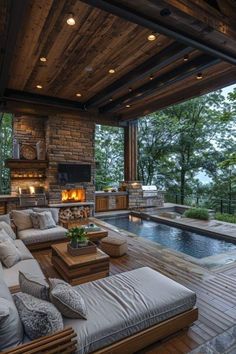 an outdoor living area with couches and fireplace