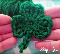 crocheted shamrock in the palm of someone's hand