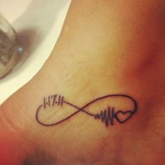 a tattoo on the foot of a person with a heart and an equalizer symbol