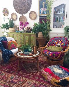 a living room filled with furniture and lots of plants