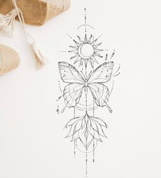 a drawing of a butterfly on a piece of paper next to some tassels