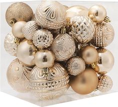 a box filled with lots of gold and silver christmas ornaments on top of each other