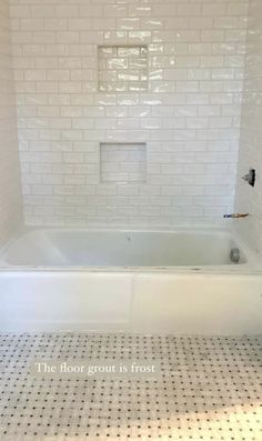 a white bath tub sitting inside of a bathroom