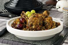 a white bowl filled with food on top of a table