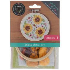 cross stitch kit with sunflowers on the front and bottom, in a package