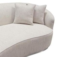 a white couch with three pillows on it's back and one pillow in the middle