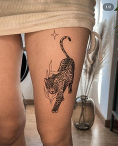 a woman's leg with a tattoo of a leopard on it